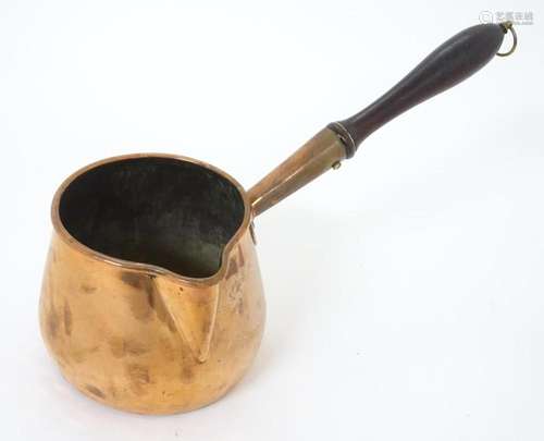 A 19thC copper saucepan with spout and turned wooden handle....