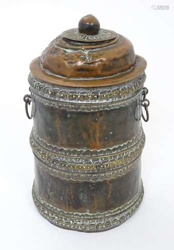 An Eastern copper lidded container of cylindrical form with ...