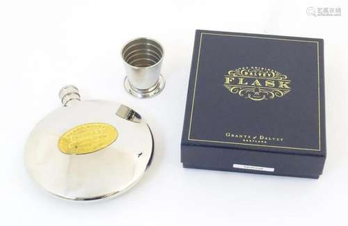 A boxed Grant's of Dalvey hip flask of circular form wit...