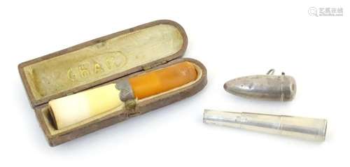 An early 20thC cased cheroot mouthpiece holder with amber st...