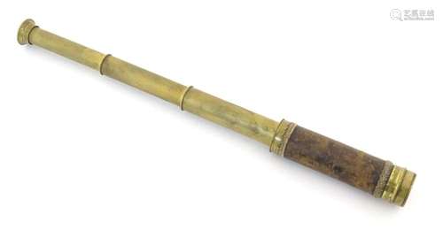 A small 20thC brass three draw telescope with leather cover....