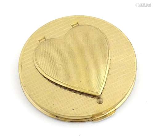 A 20thC Stratton gilt metal powder compact of circular form ...