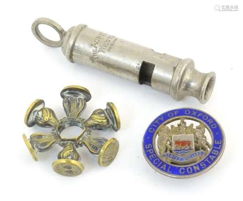 Three assorted items comprising an Acme City whistle, a cast...