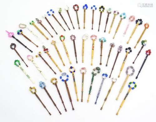 A quantity of assorted turned lace bobbins with spangles, to...