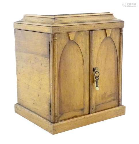 A Victorian golden oak cabinet with multiple secret drawers ...