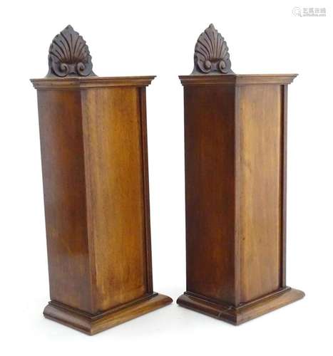 Two 19thC mahogany candle boxes with stylised foliate detail...