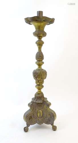 A late 19thC floor standing cast ecclesiastical candlestick ...