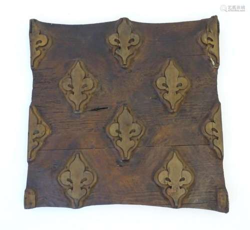 A French carved wooden wall plaque with relief fleur de lys ...