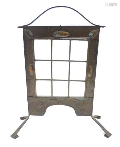 An Arts & Crafts fire screen with embossed foliate coppe...