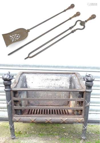 A cast iron fire basket with flame finials. Together with th...