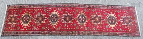 Carpet / rug : A Heriz runner, the red ground decoration wit...