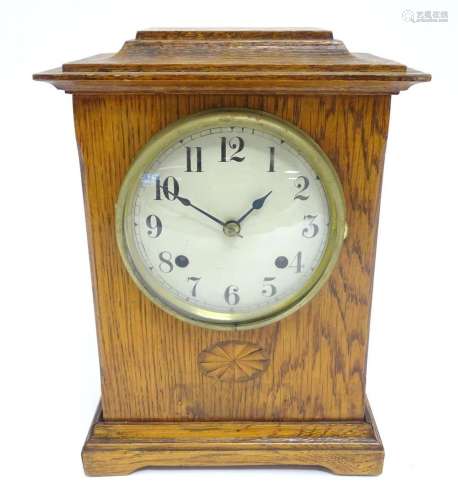 An oak cased mantle clock with 8-day movement stamped ' ...