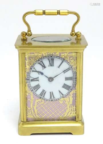 A French brass cased carriage clock with hand painted porcel...