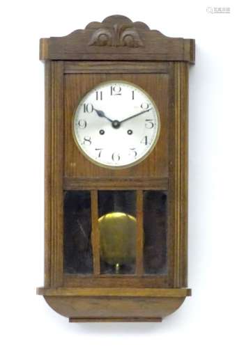 An Art deco oak wall clock. Approx 25" high