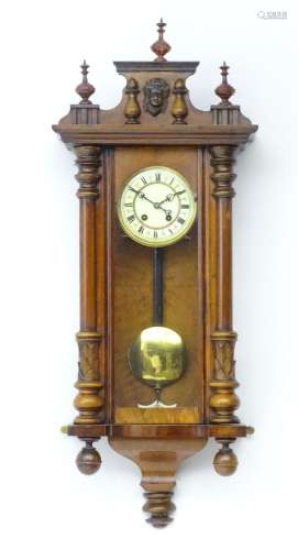 A walnut cased Vienna style wall clock. Approx 38" high...