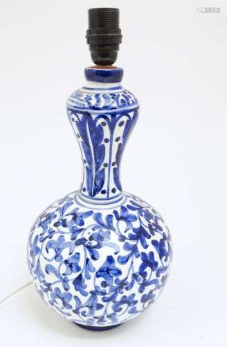 A ceramic table lamp of baluster form decorated with blue an...