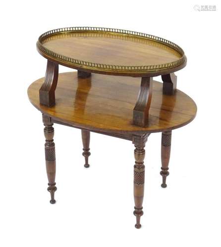 A mid / late 19thC rosewood two tier table with a brass gall...