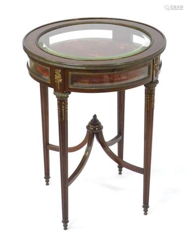 An early 20thC vitrine with a circular top having bevelled g...