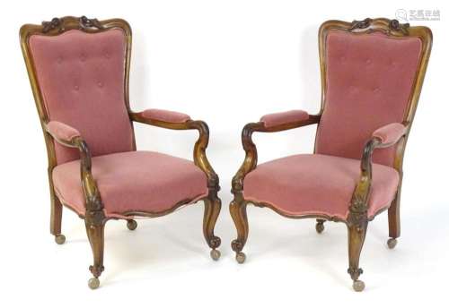 A pair of 19thC rosewood library chairs with carved cresting...