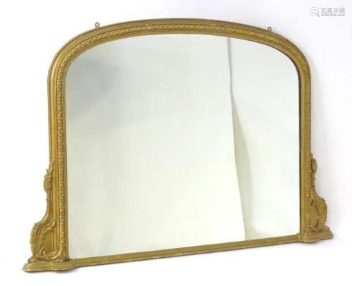 A 19thC giltwood and gesso over mantle mirror, having a bead...
