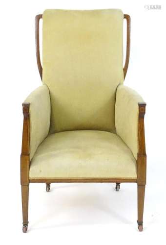 An Edwardian Art Nouveau style armchair, the armchair having...