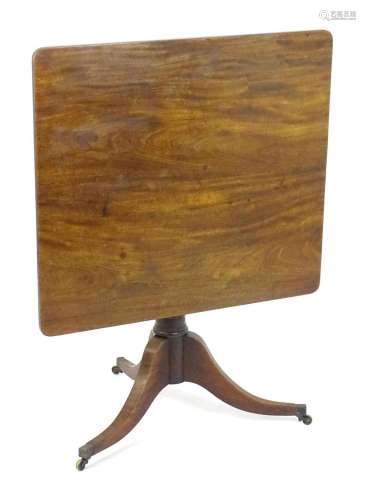 A Regency mahogany tripod table raised on three shaped legs ...