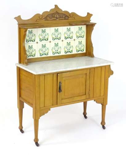 A late 19thC / early 20thC marble topped washstand with a ti...