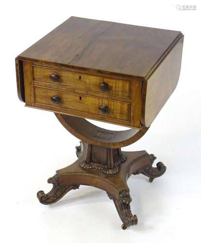 An early 19thC rosewood drop flap table, having two short dr...