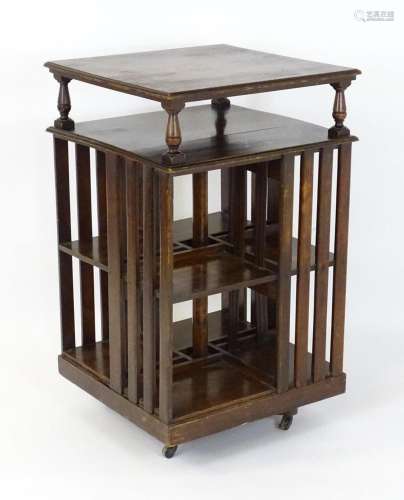 An early 20thC oak revolving bookcase of large proportions, ...