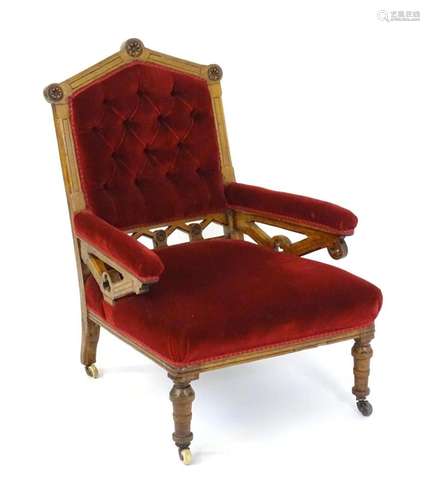 A late 19thC oak Gothic revival armchair, having a pointed t...