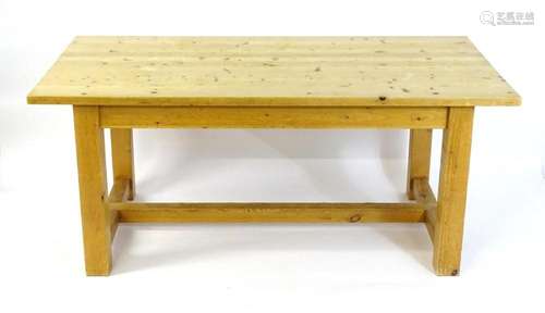 A late 20thC pine kitchen table / refectory table, having a ...