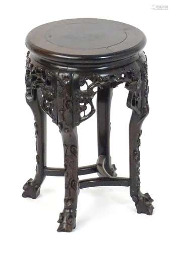 An early 20thC oriental jardiniere stand, with a circular to...