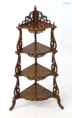 A 19thC burr walnut corner etagere, having pierced carved de...