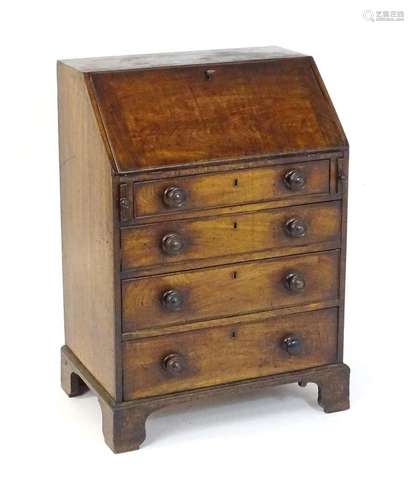 A Georgian mahogany bureau with a fall front above four long...