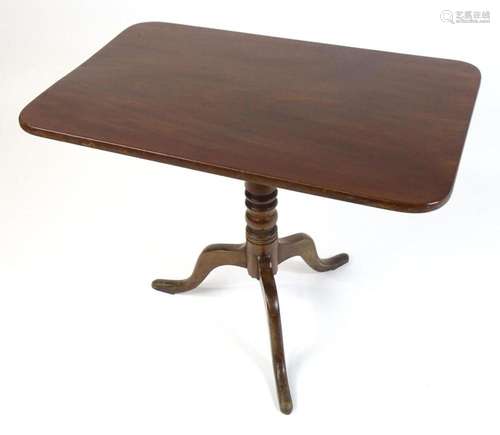 An early 19thC mahogany tripod table with a rectangular top ...