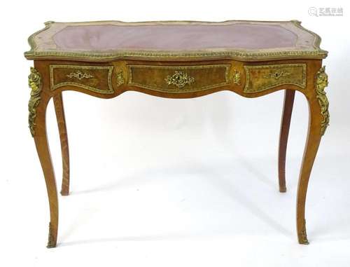 A 20thC kingwood writing desk / bureau plat, the desk having...