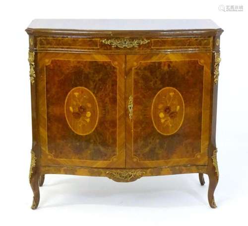 A serpentine fronted cabinet with burr veneers, inlaid decor...