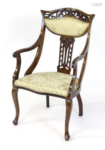 An early 20thC mahogany Art Nouveau open armchair, having a ...