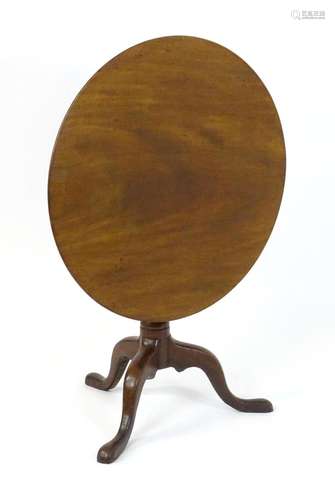 A Georgian mahogany tripod table with a circular one plank t...