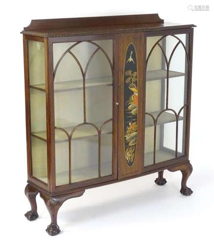 An early 20thC mahogany display cabinet, having a shaped ups...