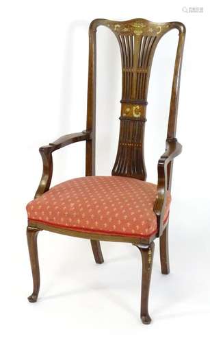 An early 20thC mahogany open armchair with a shaped top rail...