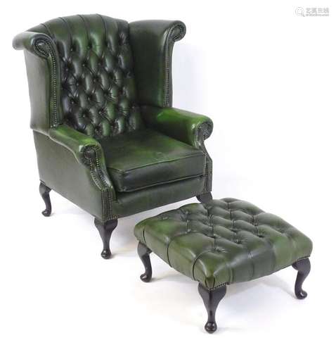 A Thomas Lloyd Georgian style wingback leather armchair with...