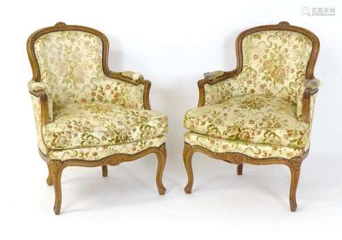 A pair of Louis XV style French armchairs with carved cresti...