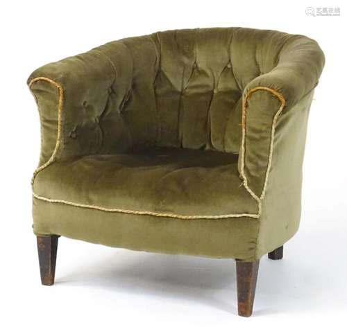 An early 20thC bow back deep buttoned tub chair raised on st...