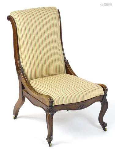 A 19thC rosewood reclining chair with a scrolled back, recli...