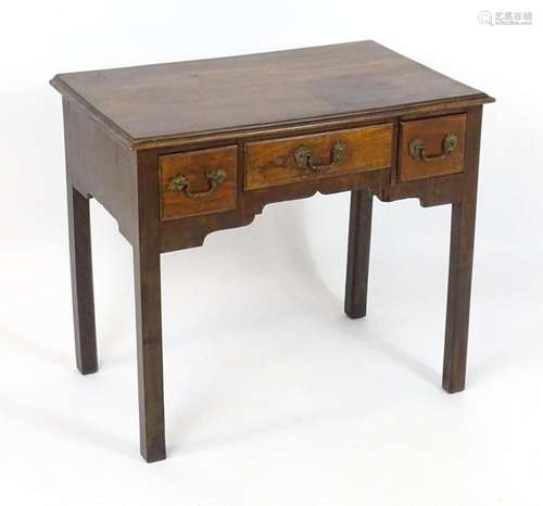 An 18thC mahogany lowboy with a moulded top above three shor...