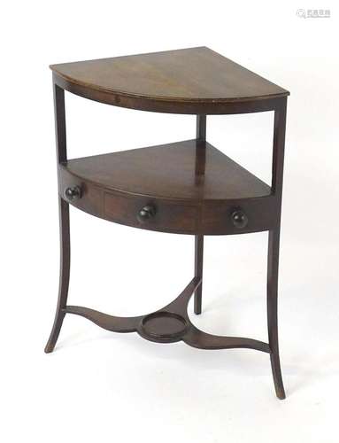 A late Georgian mahogany corner washstand, having two tiers ...