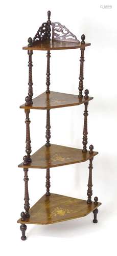 A late 19thC walnut four tier corner whatnot, surmounted by ...