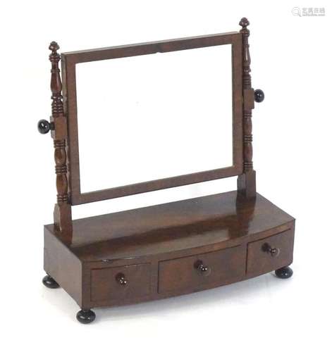 An early 19thC mahogany toilet mirror, having turned upright...