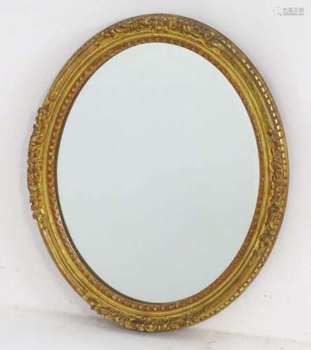 A 20thC oval mirror with giltwood and gesso surround. Approx...